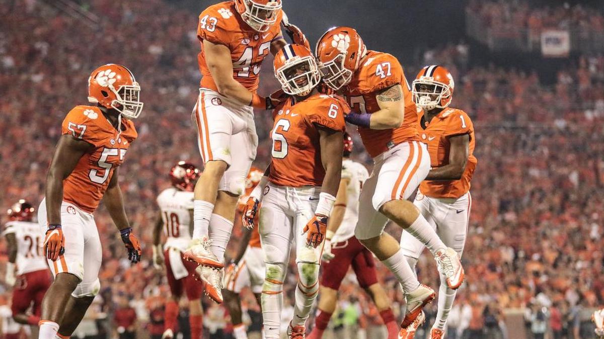 Clemson defenders Chad Smith, Dorian O'Daniel and James Skalski (47) celebrate a sack against Louisville this past season.