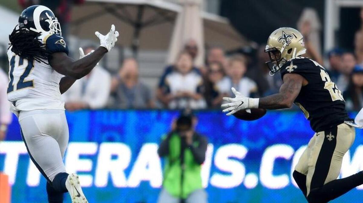 New Orleans Saints running back Mark Ingram, right, intercepts a pass intended for Los Angeles Rams wide receiver Sammy Watkins during the second half of an NFL football game Sunday, Nov. 26, 2017, in Los Angeles.