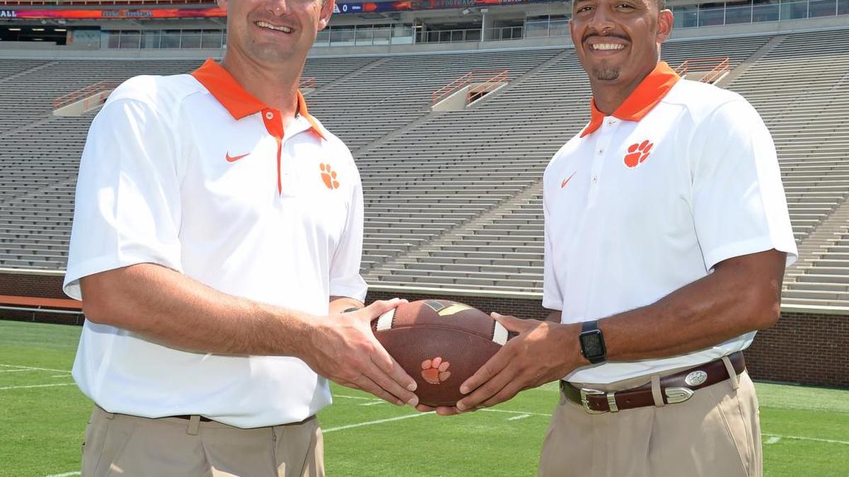Clemson co-offensive coordinators Tony Elliott (right) and Jeff Scott like what they see in freshman running back Travis Etienne.