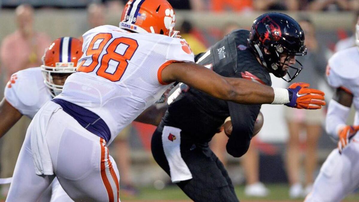 
Clemson Tigers defensive end Kevin Dodd (98) sacks Louisville Cardinals quarterback Kyle Bolin (14) during the first quarter at Papa John's Cardinal Stadium. Mandatory Credit: Jamie Rhodes-USA TODAY Sports
