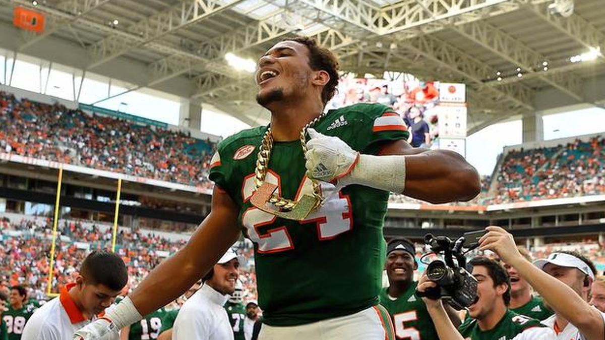 Miami players celebrate with a turnover chain after creating a turnover.