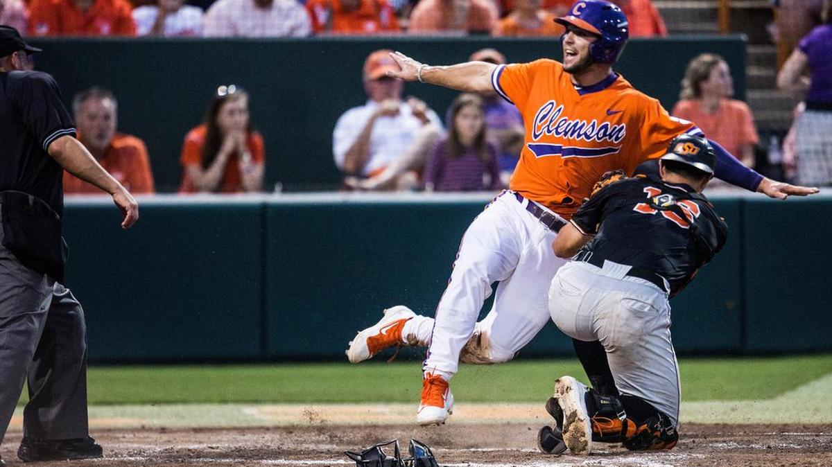 Clemson's Andrew Cox is tagged out while sliding into home by Oklahoma State's Collin Theroux on Saturday in the Tigers’ loss.