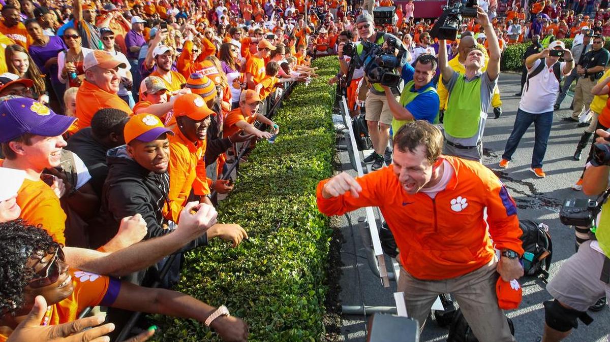 Clemson coach Dabo Swinney celebrates the Tigers win with fans after the Palmetto Bowl at Williams-Brice Stadium.