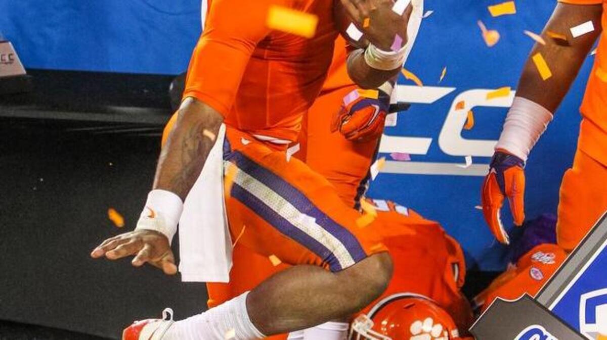 Clemson quarterback Deshaun Watson (4) takes the ACC Championship trophy and strikes the Heisman pose after they beat North Carolina 45-37 at Bank of America Stadium, in Charlotte, NC.