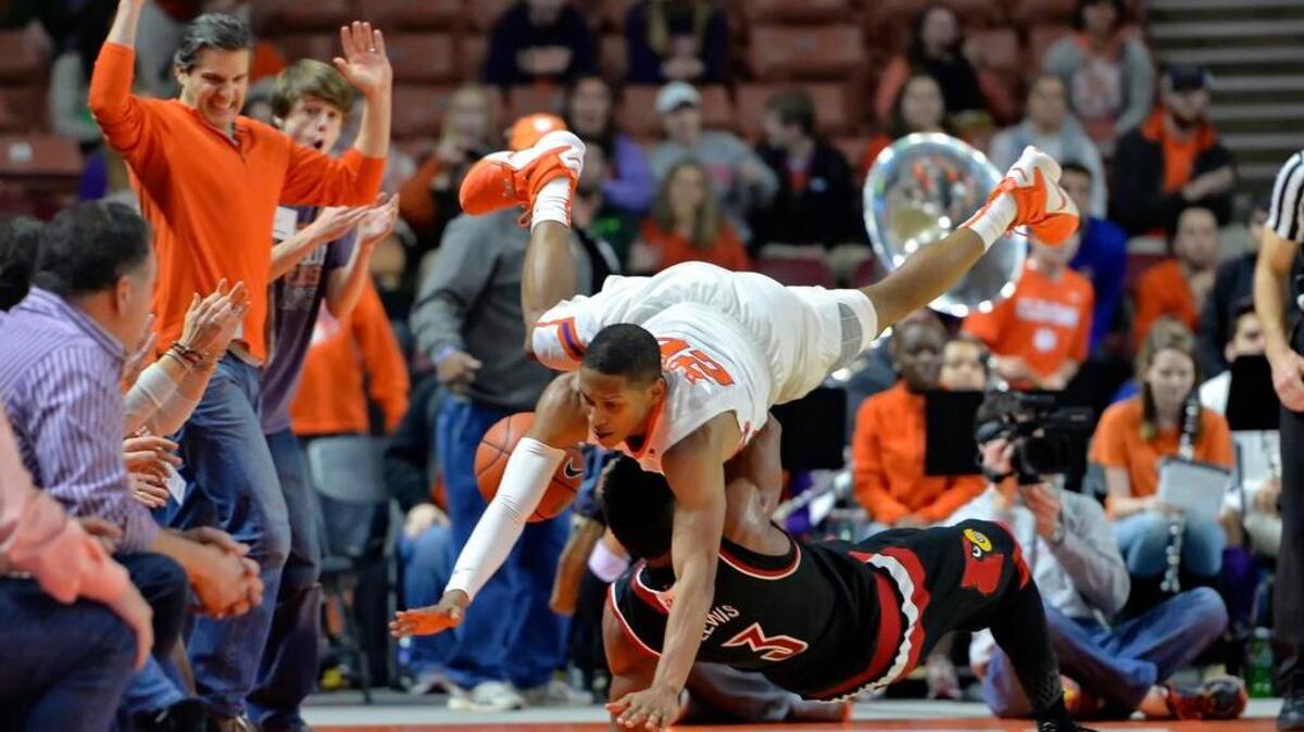 Clemson's Jordan Roper, top, collides with Louisville's Trey Lewis (3) during the second half of an NCAA college basketball game Sunday, Jan. 10, 2016, in Greenville.