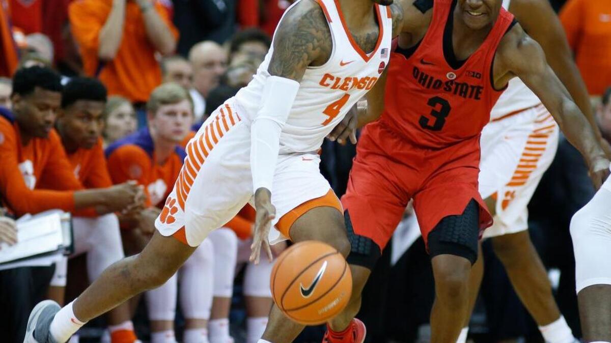 Clemson's Shelton Mitchell, left, dribbles past Ohio State’s C.J. Jackson during the second half of an NCAA college basketball game Wednesday, Nov. 29, 2017, in Columbus, Ohio. Clemson beat Ohio State 79-65.
