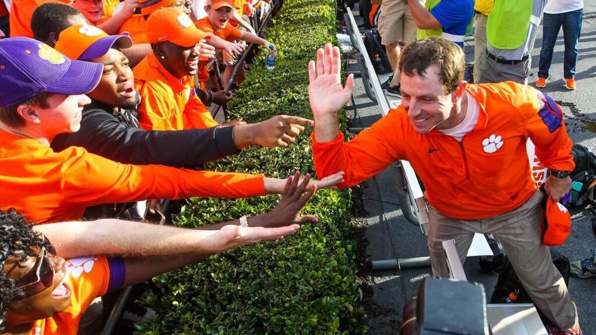 Clemson head coach Dabo Swinney celebrates the Tigers win with fans after the USC-Clemson game this past season at Williams-Brice Stadium.