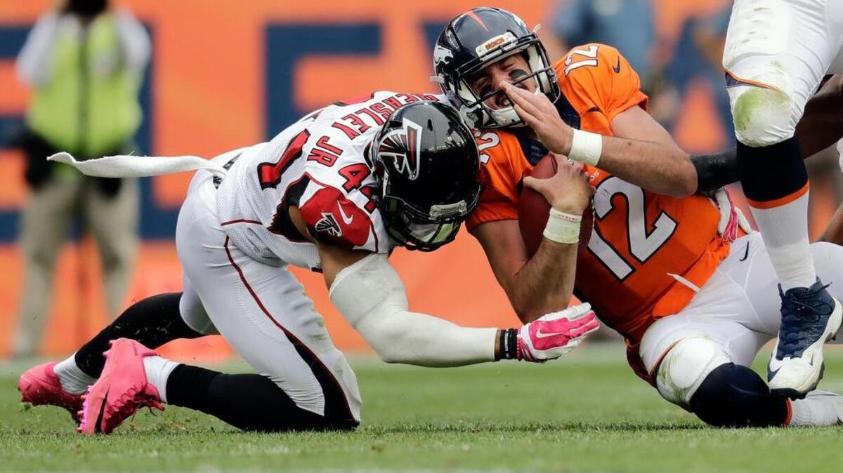 Atlanta outside linebacker Vic Beasley hits Denver quarterback Paxton Lynch.