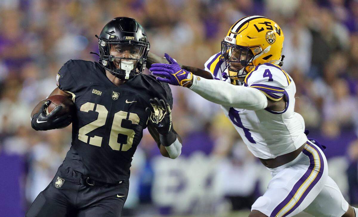 Oct 21, 2023; Baton Rouge, Louisiana, USA; Army Black Knights running back Kanye Udoh (26) is hit by LSU Tigers linebacker Harold Perkins Jr. (4) on a run during the first half at Tiger Stadium.