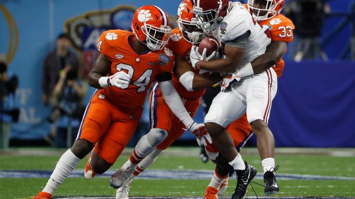 Jan 1, 2018; New Orleans, LA, USA; Clemson Tigers linebacker Kendall Joseph (34) and linebacker Dorian O'Daniel (6) and linebacker J.D. Davis (33) tackle Alabama Crimson Tide running back Damien Harris (34) during the first quarter of the 2018 Sugar Bowl college football playoff semifinal game at Mercedes-Benz Superdome.