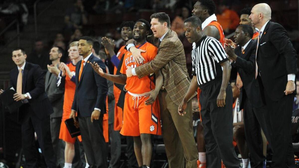 Clemson Tigers head coach Brad Brownell grabs a hold of guard Ty Hudson (11)