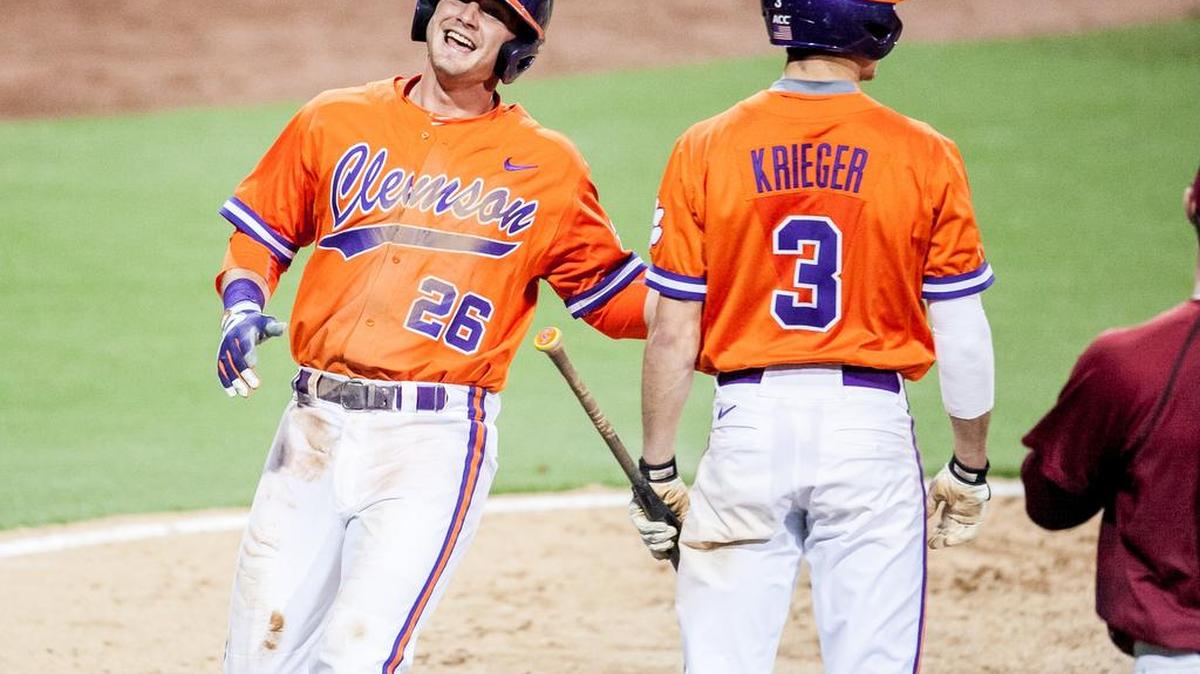 Clemson left fielder Reed Rohlman (26) celebrates scoring.