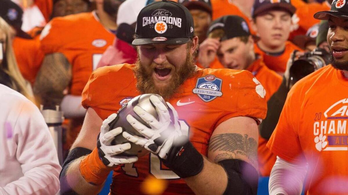 Clemson offensive lineman Eric Mac Lain holds the ACC trophy after the Tigers’ win over North Carolina earlier this season.