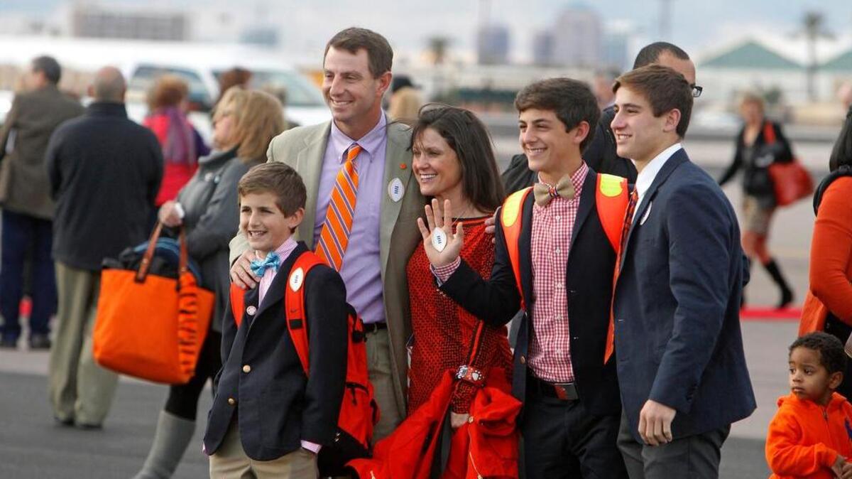 Clemson University head coach Dabo Swinney and his family take pictures after arriving at Phoenix Sky Harbor Executive Terminal on Friday.