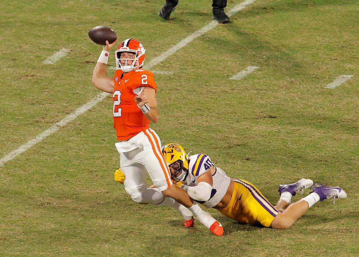 Clemson quarterback Cade Klubnik (2) is forced to throw the ball away under pressure from LSU linebacker Whit Weeks (40) during second-half action in Clemson, S.C. on Saturday, Aug. 30, 2025.