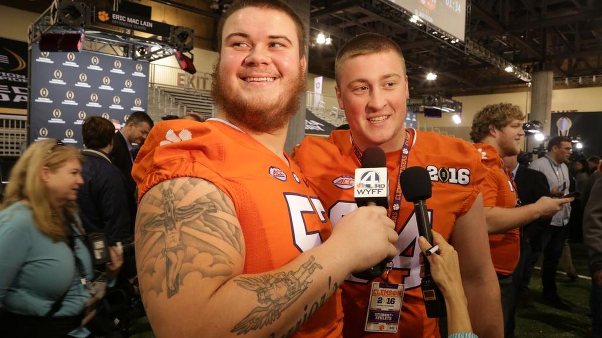 Clemson Tigers center Jay Guillermo (57) interviews teammate Pat Godfrey (64) during Media Day before the National Championship game.