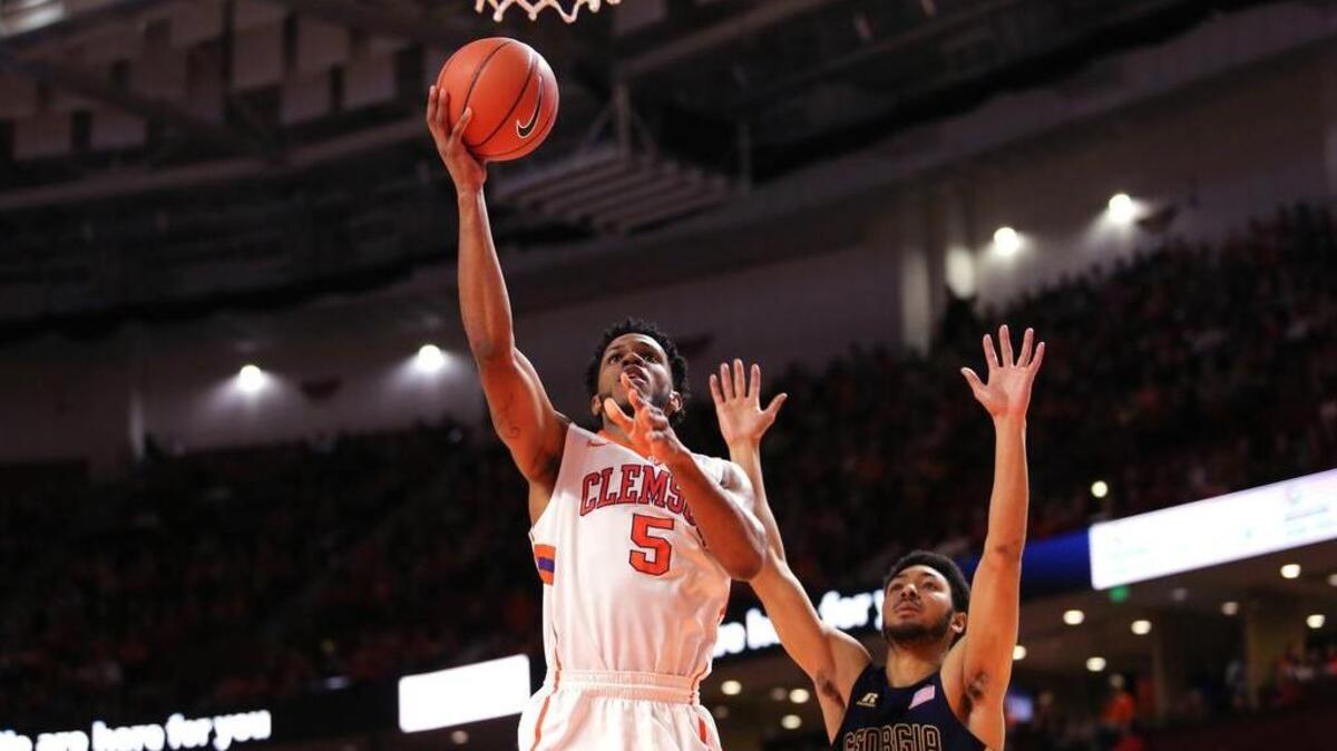 Clemson forward Jaron Blossomgame goes up over Georgia Tech guard Josh Heath in the first half for two of his team-high 17 points in the Tigers’ victory over the Yellow Jackets.