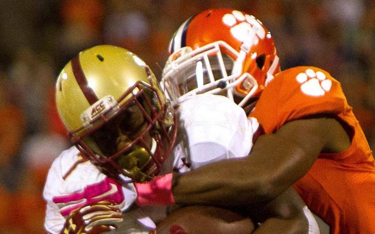 
Boston College running back Marcus Outlow is tackled by Clemson safety T.J. Green.
