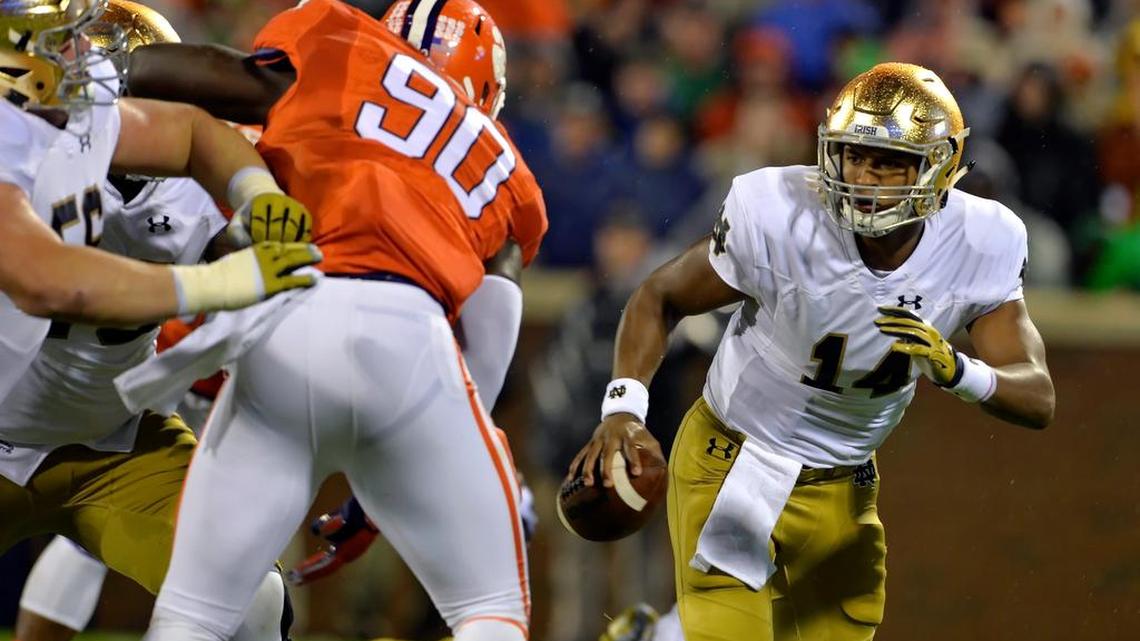 
Notre Dame quarterback DeShone Kizer, right, scrambles out of the pocket while pressured by Clemson's Shaq Lawson during the first half of an NCAA college football game Saturday, Oct. 3, 2015, in Clemson, S.C.
