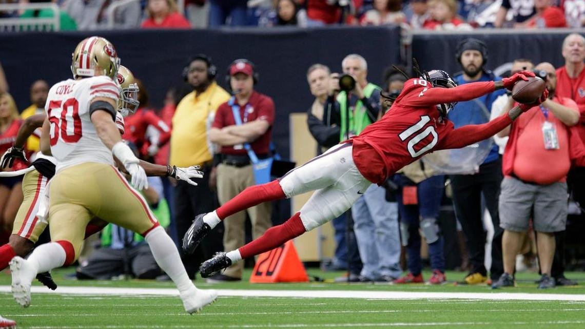 Houston Texans wide receiver DeAndre Hopkins (10) stretches out to make a catch against the San Francisco 49ers during the first half of an NFL football game, Sunday, Dec. 10, 2017, in Houston.