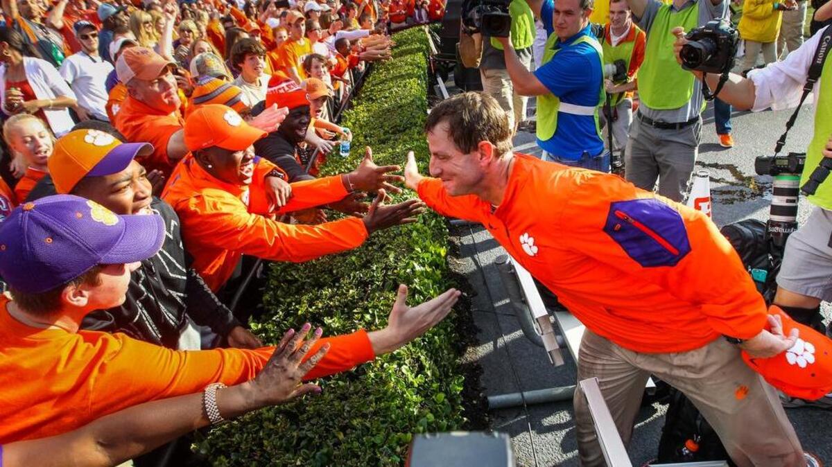 Clemson head coach Dabo Swinney celebrates the Tigers win with fans after the USC-Clemson game Saturday at Williams-Brice Stadium.
