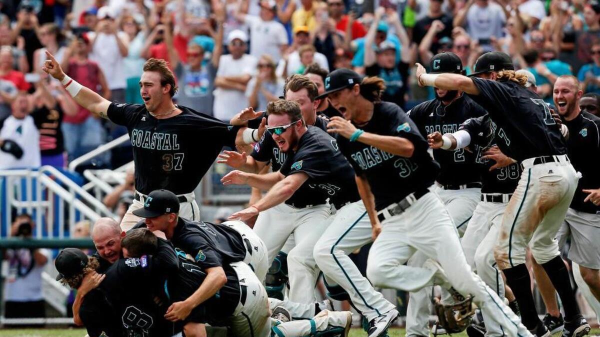 Coastal Carolina Chanticleers players celebrate after winning the championship against the Arizona Wildcats in game three of the College World Series championship series at TD Ameritrade Park