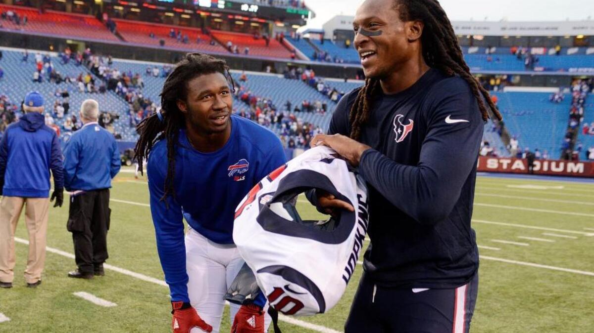 Former Clemson WRs Sammy Watkins (left), then with the Buffalo Bills, exchanges jerseys with Houston Texans wide receiver DeAndre Hopkins.