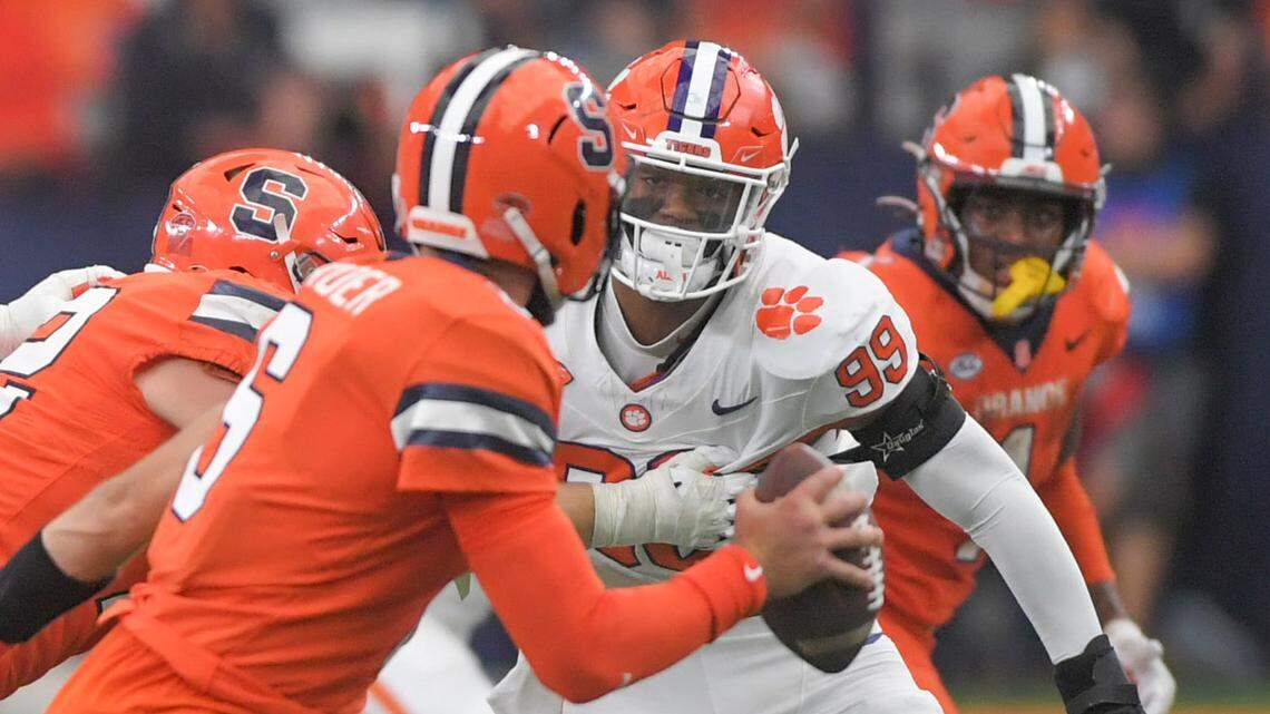 Clemson defensive end A.J. Hoffler (99) pursues Syracuse quarterback Garrett Shrader (6) during the fourth quarter of a 2023 game.