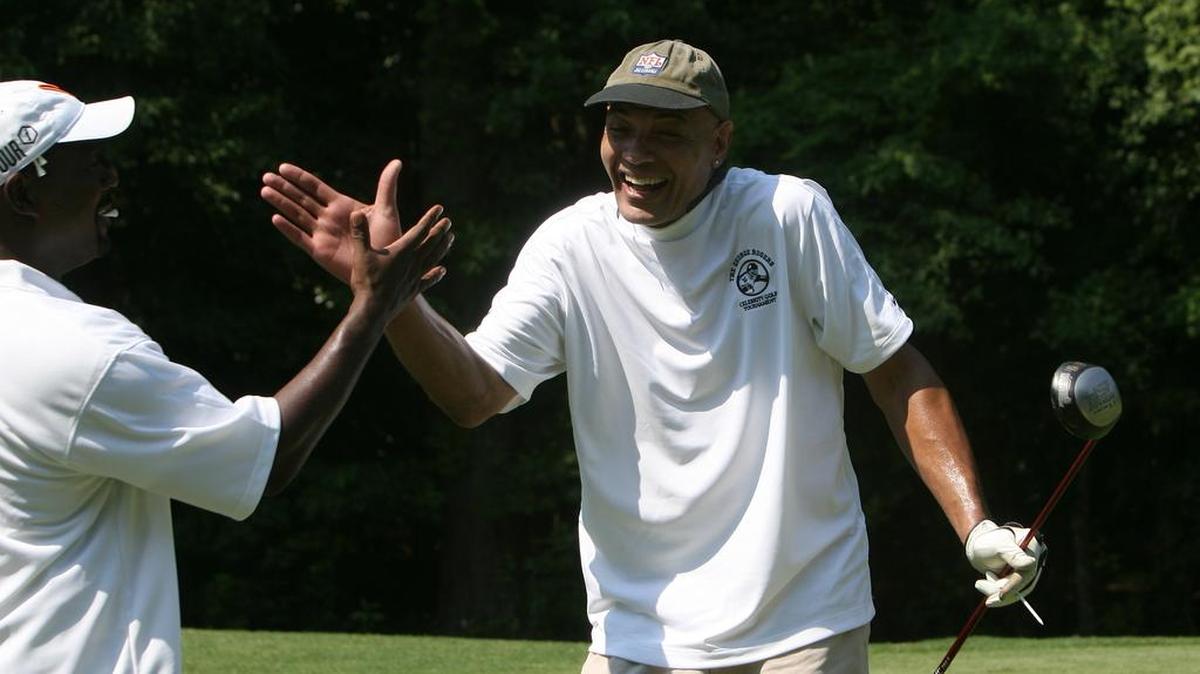 Former Clemson and Pittsburgh Steelers tight end Bennie Cunningham celebrates with a teammate after splitting the fairway at the George Rogers Celebrity Golf Tournament in 2010.