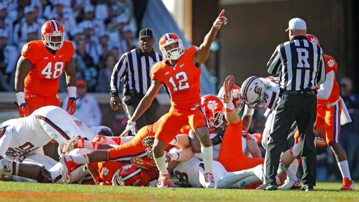 
Clemson Tigers safety Korrin Wiggins (12) celebrates after stopping South Carolina Gamecocks quarterback Dylan Thompson (17) on a fourth down play.
