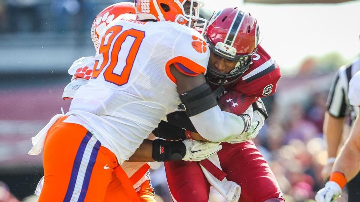 Clemson defensive end Shaq Lawson (90) sacks South Carolina quarterback Lorenzo Nunez (19) during the USC-Clemson game Saturday at Williams-Brice Stadium.