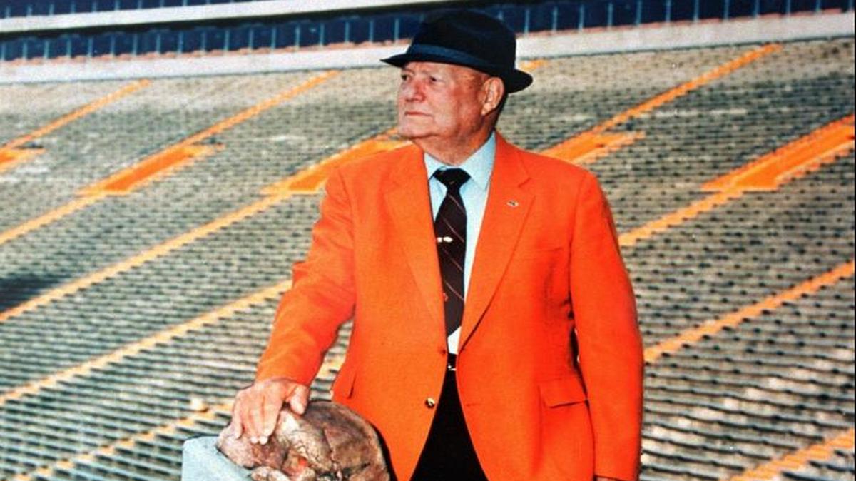 Former Clemson football coach Frank Howard is shown in this 1990 photo with his hand on "Howard's Rock."