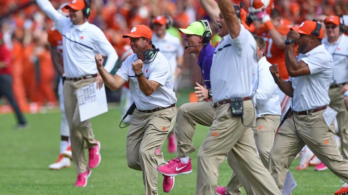Clemson coach Dabo Swinney, center, along with staff members, reacts during the second half of an NCAA college football game against North Carolina State Saturday, Oct. 15, 2016, in Clemson, S.C. Clemson won 24-17 in overtime.