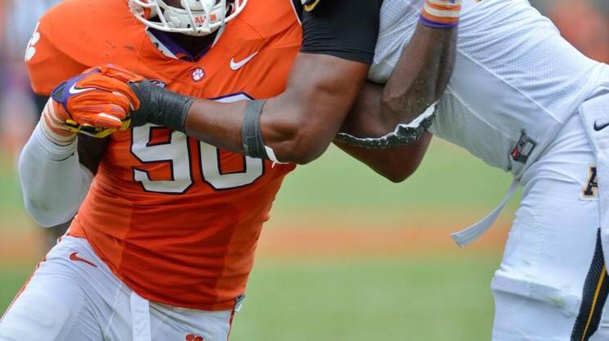 
Clemson’s Shaq Lawson, left, works against Appalachian State’s Davante Harris during Saturday’s game. Lawson had to leave the game with the help of trainers at one point in the game, but returned immediately.
