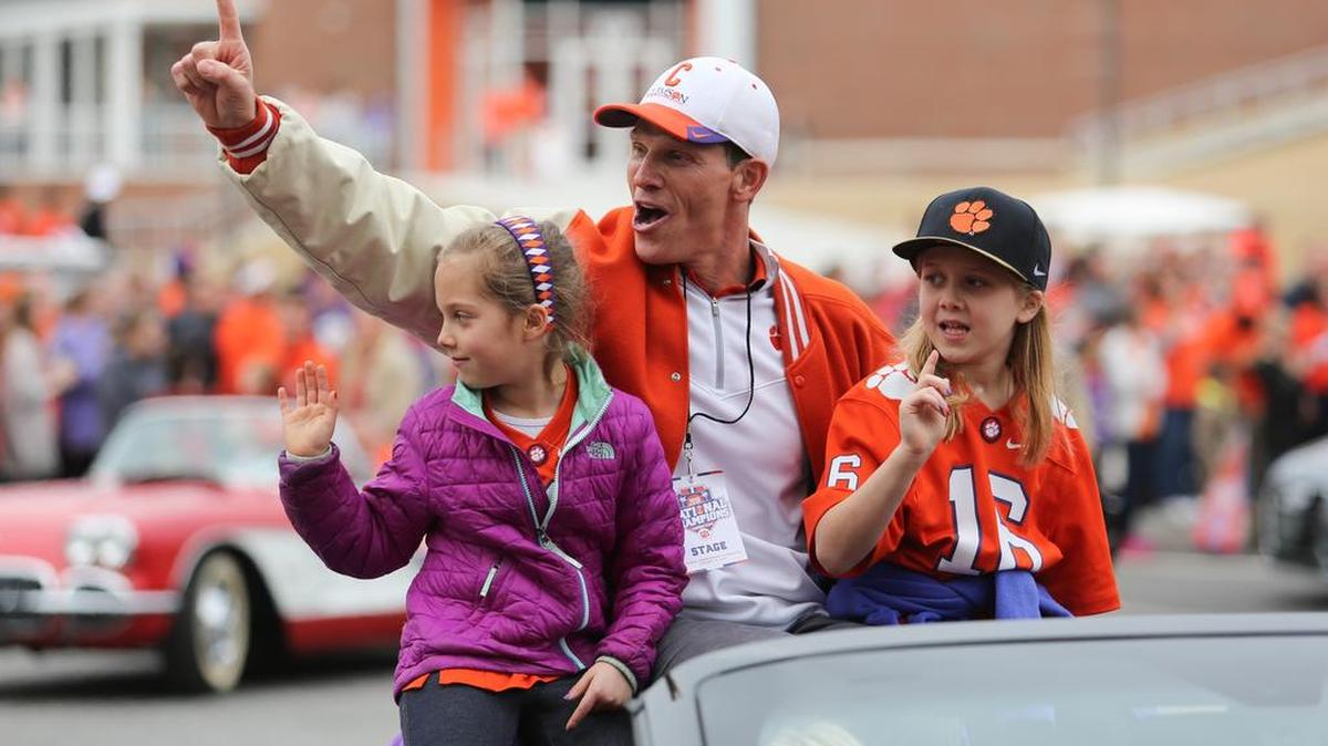 Clemson Tigers defensive coordinator Brent Venables and his daughters greet fans during the College Football Playoff National Championship celebration parade in downtown Clemson this past January.