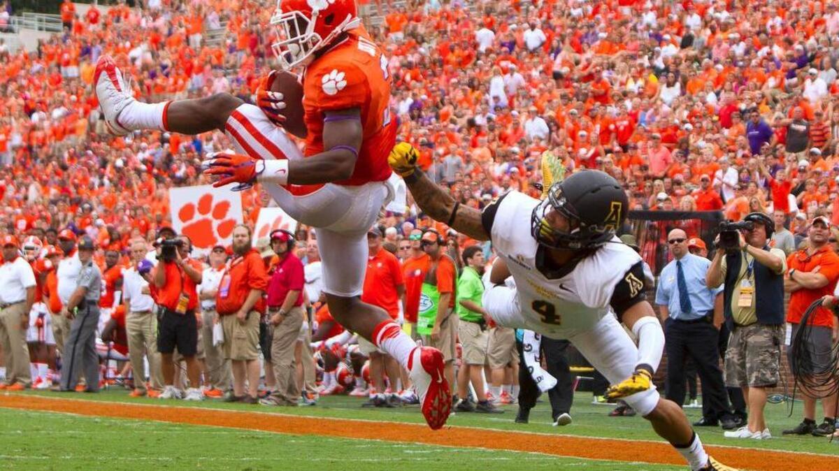 
Clemson receiver Artavis Scott scores a touchdown while being defended by Appalachian State defensive back Mondo Williams during the second half at Clemson Memorial Stadium.
