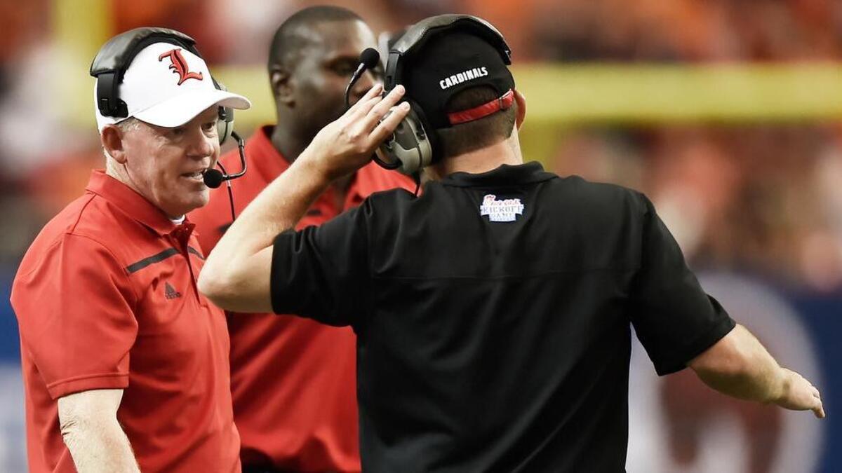 
Louisville head coach Bobby Petrino speaks to coaches during the first half against Auburn, Saturday, Sept. 5, 2015, in Atlanta. 
