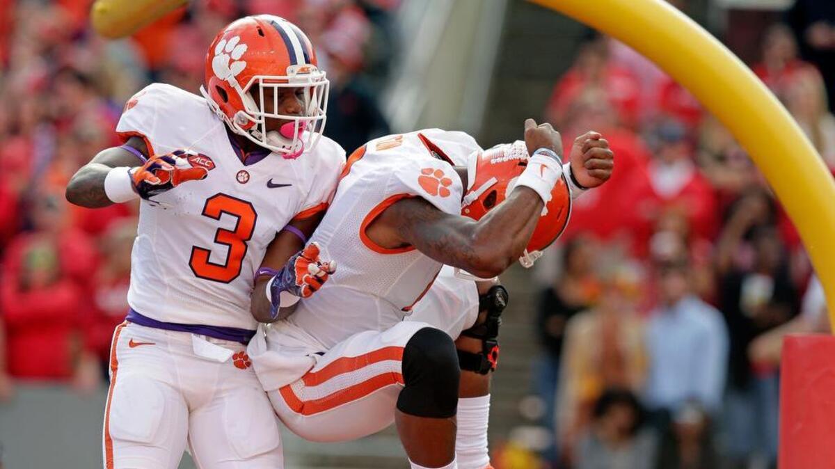 Clemson’s Artavis Scott (3) and Deshaun Watson celebrate the quarterback’s touchdown against North Carolina State.