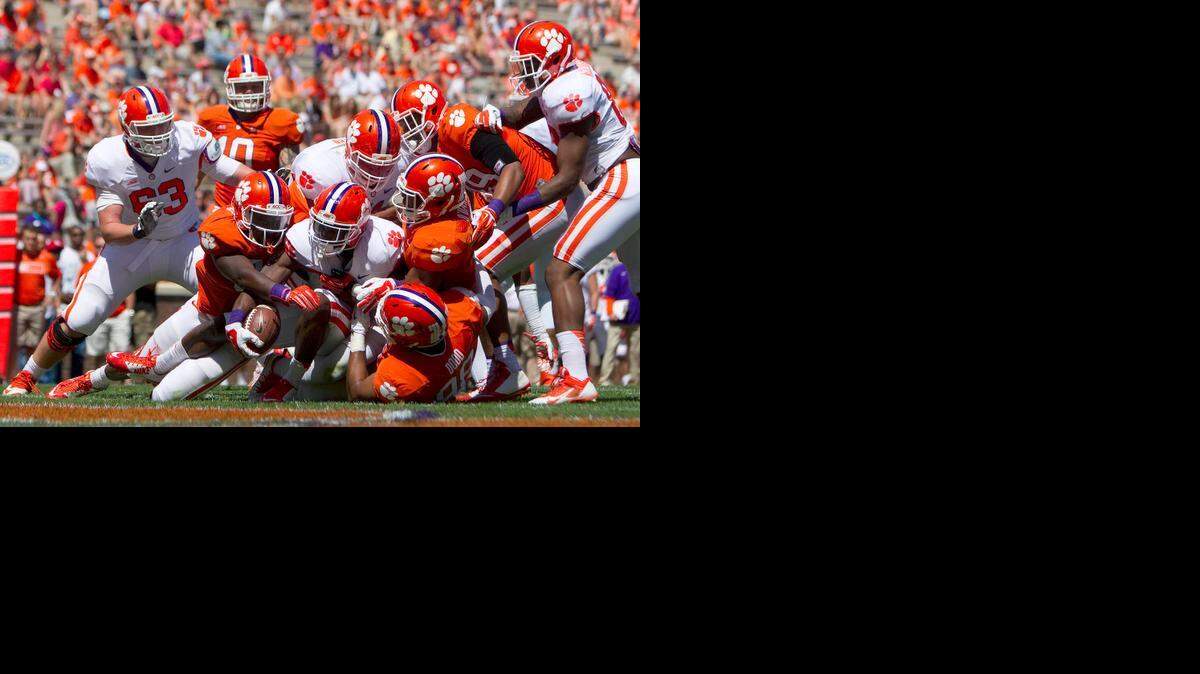 
Clemson Tigers running back C.J. Davidson (21) is brought down by defensive end Kevin Dodd (98) during the first half of the Clemson spring game at Clemson Memorial Stadium. Mandatory Credit: Joshua S. Kelly-USA TODAY Sports
