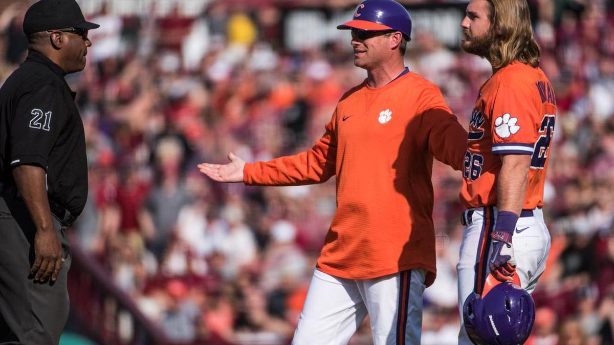 Clemson head coach Monte Lee, with Reed Rohlman, right, questions an umpire's call. Rohlman owns an 18-game hitting streak.