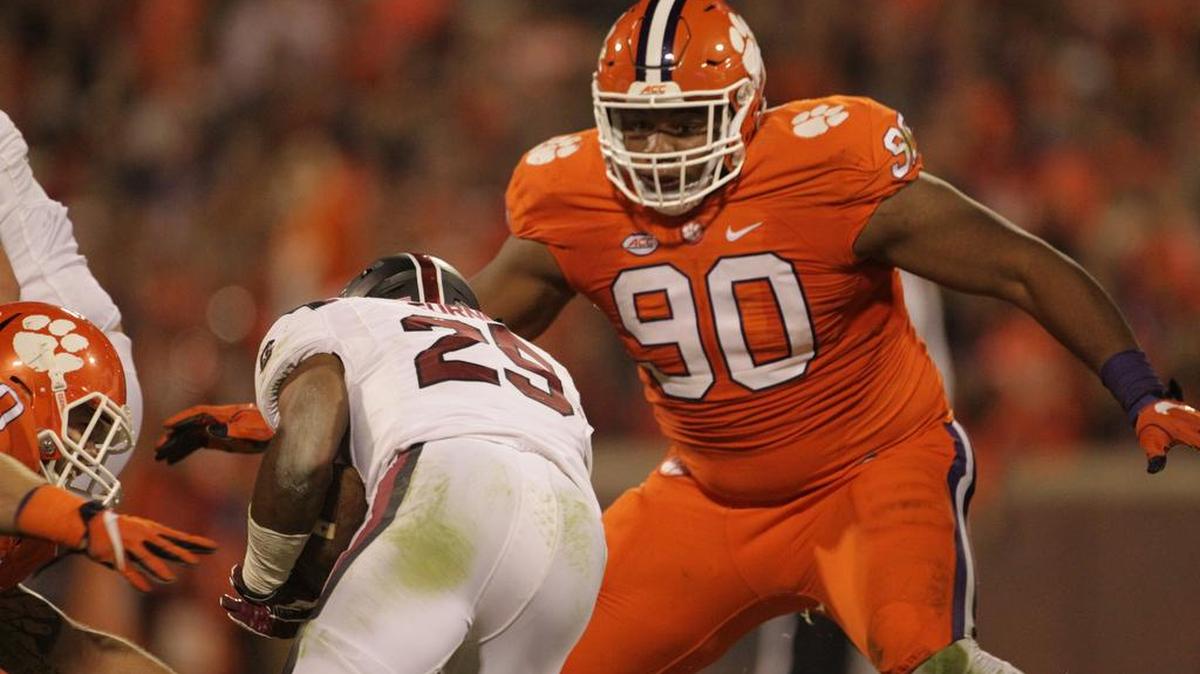 Clemson Tigers defensive tackle Dexter Lawrence (90) closes in on South Carolina Gamecocks running back A.J. Turner this past season.