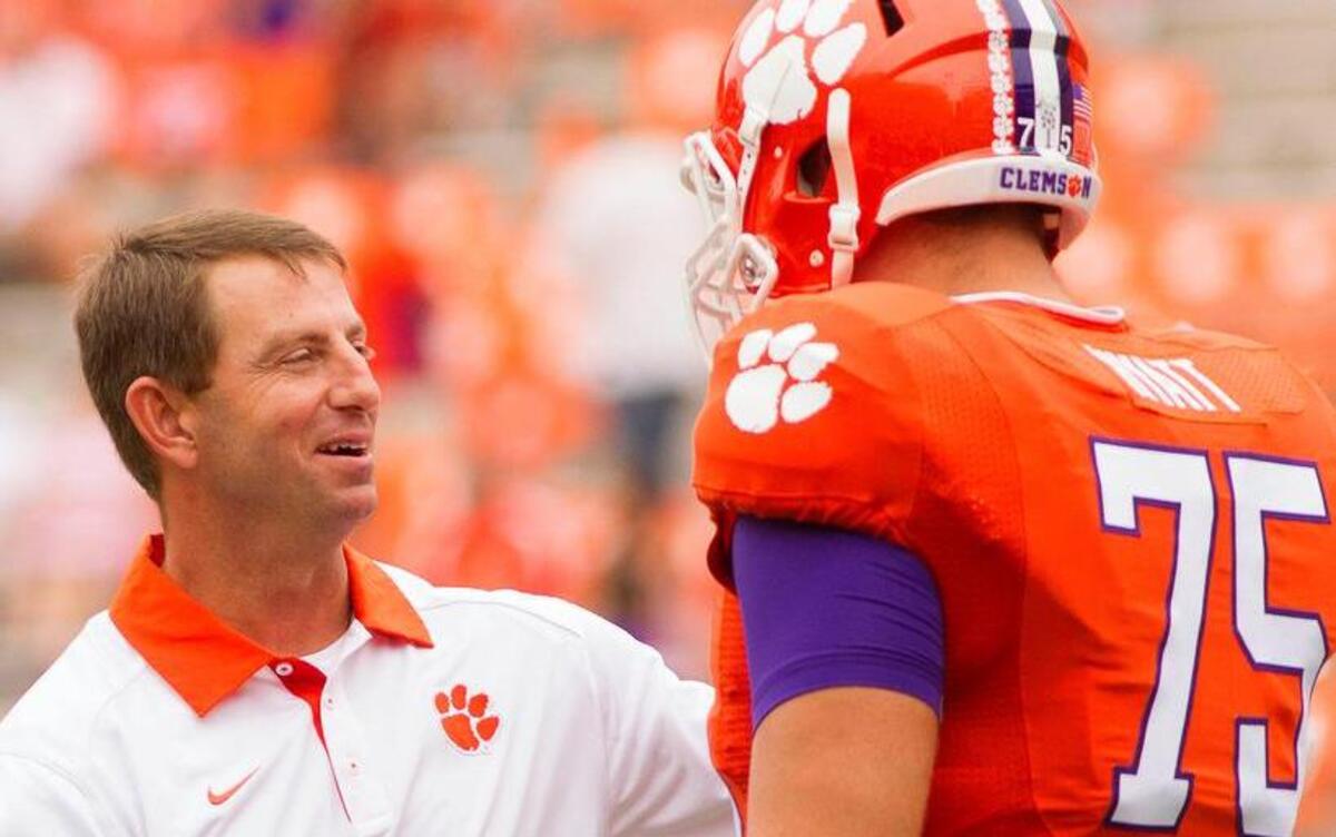 Clemson Tigers head coach Dabo Swinney speaks with offensive lineman Mitch Hyatt (75)