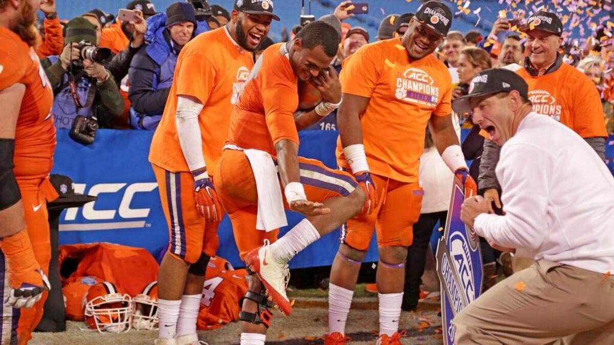No Tigers had a better season than quarterback Deshaun Watson, doing the Heisman pose, and coach Dabo Swinney, who celebrated their win over North Carolina to claim the ACC Championship.