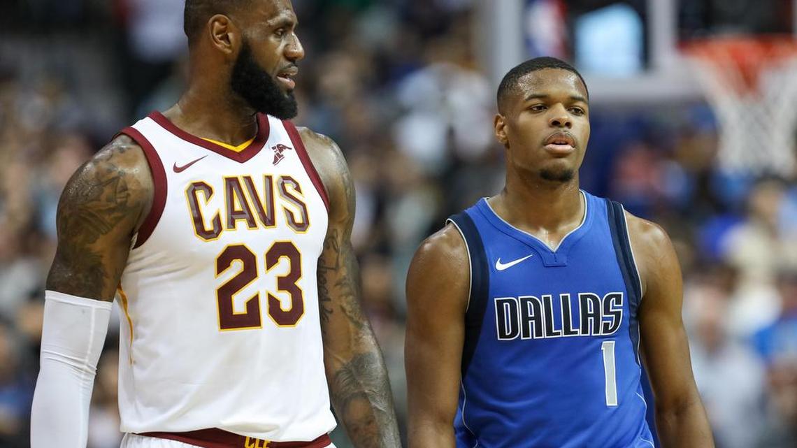 Cleveland Cavaliers forward LeBron James (23) talks to Dallas Mavericks guard Dennis Smith Jr. (1) as they walk up the court during the fourth quarter at American Airlines Center.