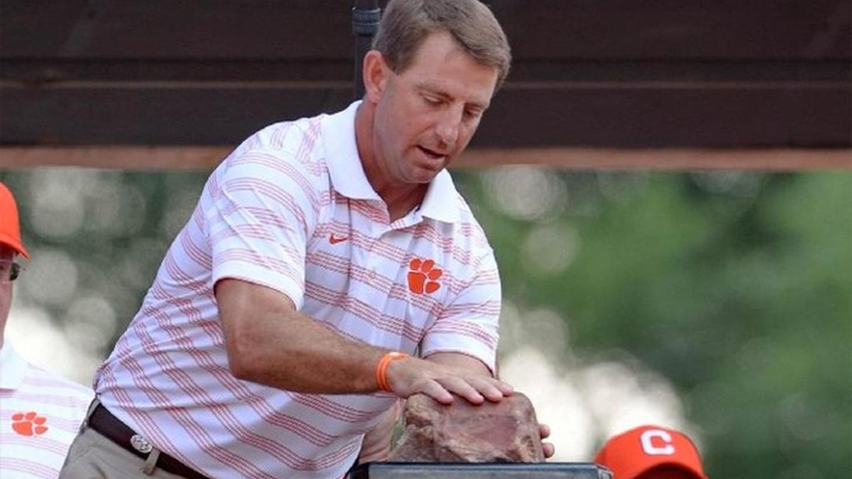 In this Sept. 6, 2014, file photo, Clemson coach Dabo Swinney rubs Howard's Rock before Clemson's NCAA college football game against South Carolina State in Clemson, S.C.