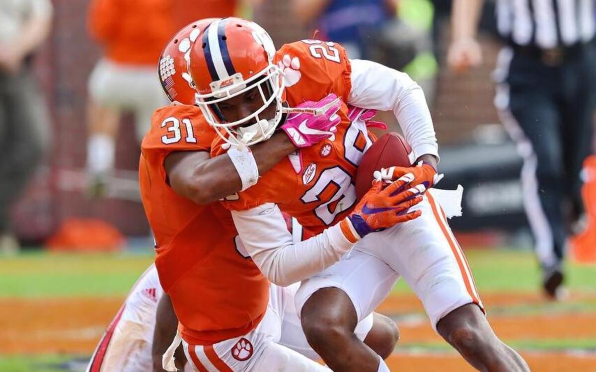 Clemson’s Marcus Edmond (29) and Ryan Carter (31) celebrate Edmonds’ game-ending interception on Saturday.