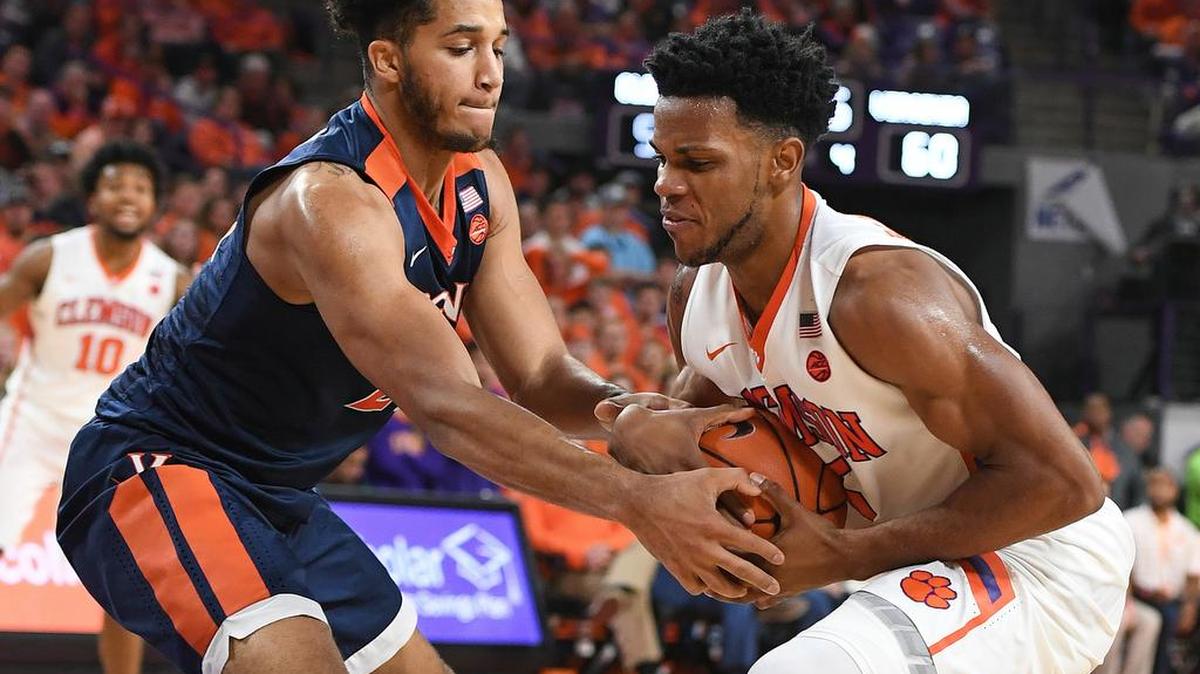Virginia forward Isaiah Wilkins, left, fights for the ball with Clemson forward Jaron Blossomgame (5) during their game Saturday at Littlejohn Coliseum.