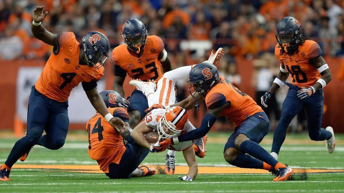 Clemson wide receiver Hunter Renfrow (13) is upended by Syracuse defensive back Evan Foster (14) and defensive back Jordan Martin (2) during their game Friday night.