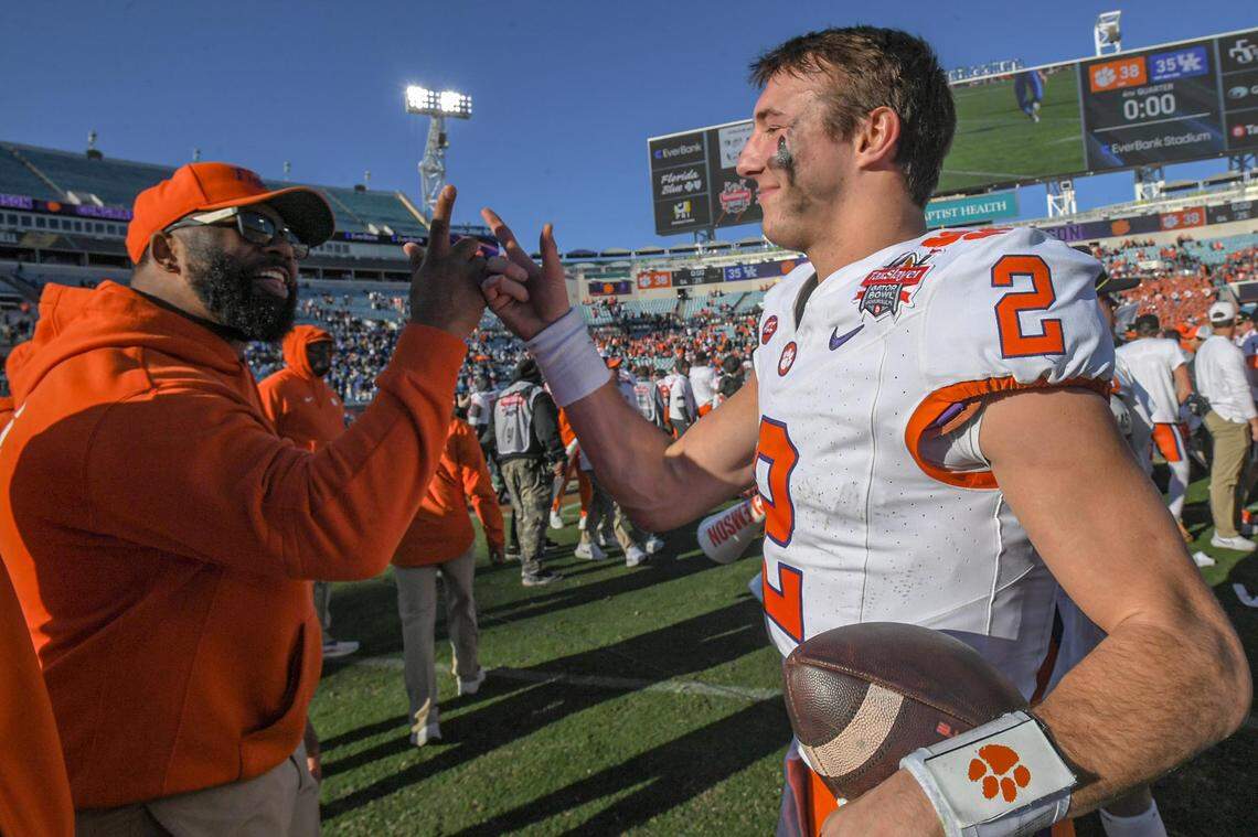 Clemson quarterback Cade Klubnik (2), right, celebrates with Tajh Boyd after winning the 2023 Gator Bowl vs. Kentucky in Jacksonville, Florida