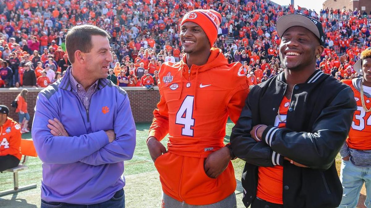 Clemson coach Dabo Swinney talks with Clemson quarterback Deshaun Watson (4) and wide receiver Artavis Scott (3) during his pizza party at Memorial Stadium on Sunday. Each person that came received a free piece of pizza and Swinney and the team came out to listen to the College Football Playoff pairings announced on ESPN.